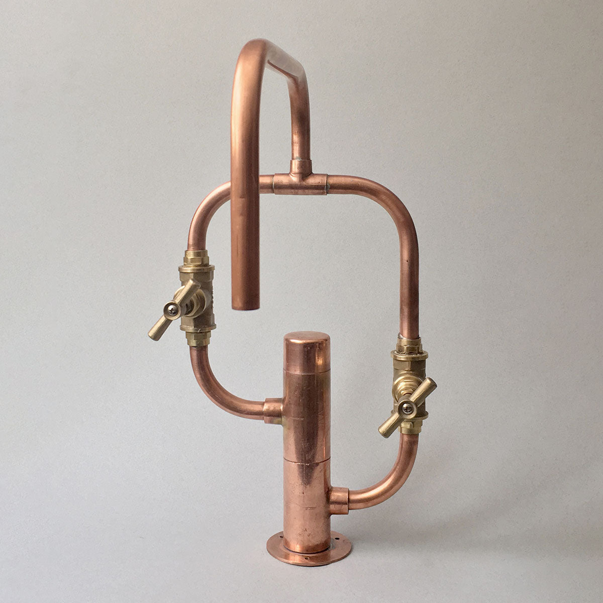 Handmade by Switchrange, the Pedestal Diagonal is a versatile copper faucet suitable for use in kitchens and bathrooms, both inside and outside.