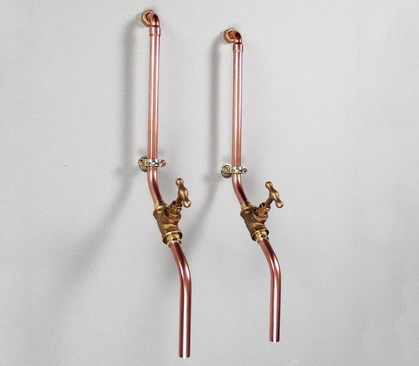 pair of minimal wall mounted taps made by hand in solid copper pipe and brass valve
