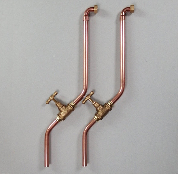 pair of minimal wall mounted taps made by hand in solid copper pipe and brass valve