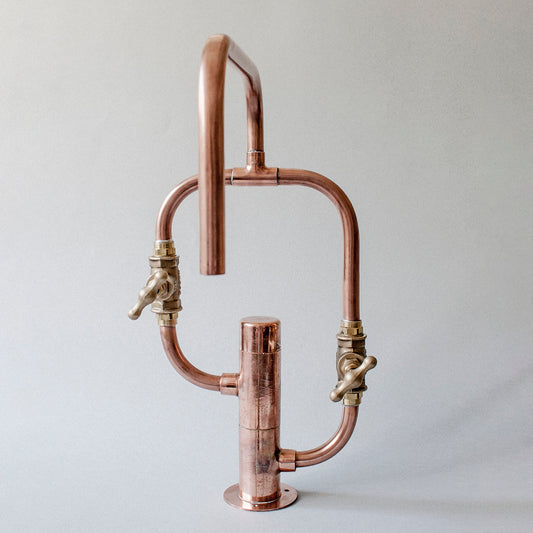 Pedestal Diagonal is a copper faucet crafted from exposed piping and brass, designed for kitchen or bathroom use indoors or outdoors, by Switchrange.